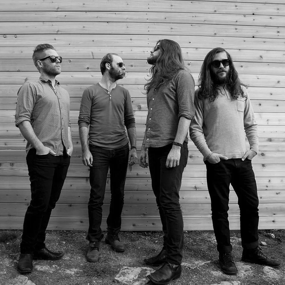 The Silent Comedy: the band against a wooden wall