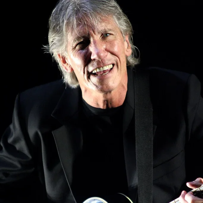 Roger Waters performing live with a guitar